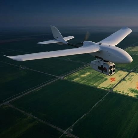  Fixed wing drone in flight carrying multispectral sensor over agricultural field