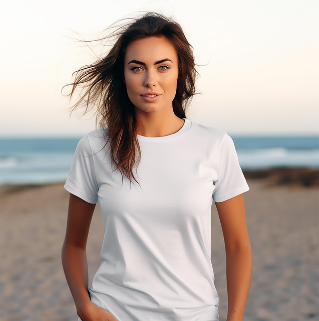 A woman modeling a short sleeved white t-shirt on the beach. 