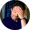 A man placing his hand to his head, displaying frustration.
