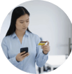 Women holding her mobile phone while looking at her bank card