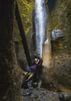 a couple in a canyon waterfall at sombre beach