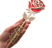 a person holding a wooden rose on a white background