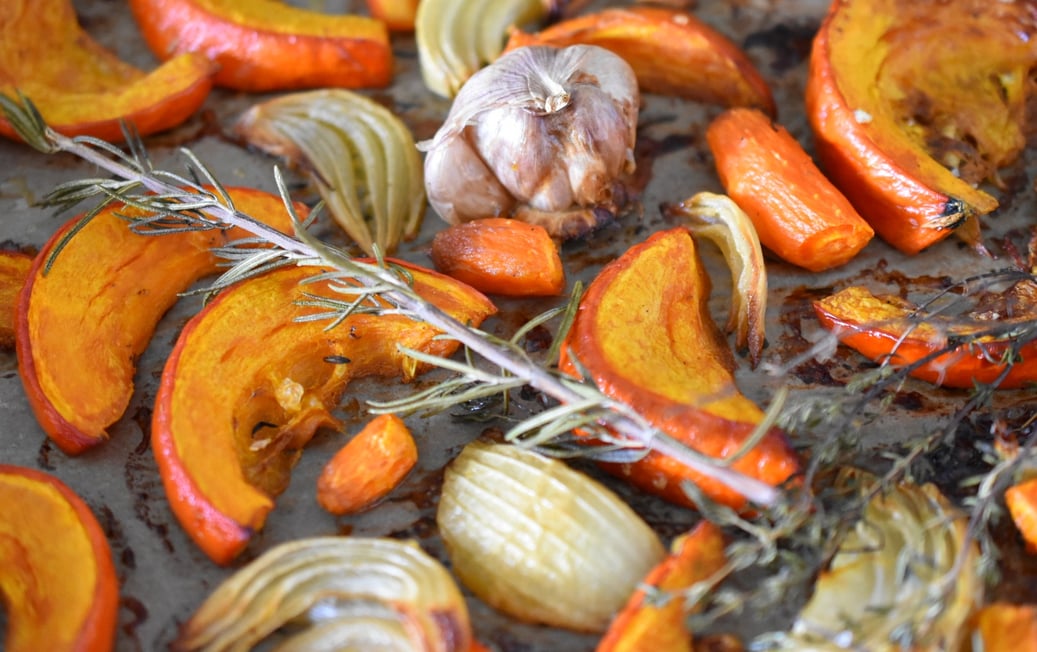 roasted pumpkin and herbs on a tray