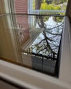 a window with a view of a tree in the background