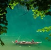 a man fishing in a lake with a boat
