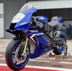 the new Yamaha R9 blue motorcycle parked in front of a building