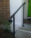 a white staircase with a black modern handrail