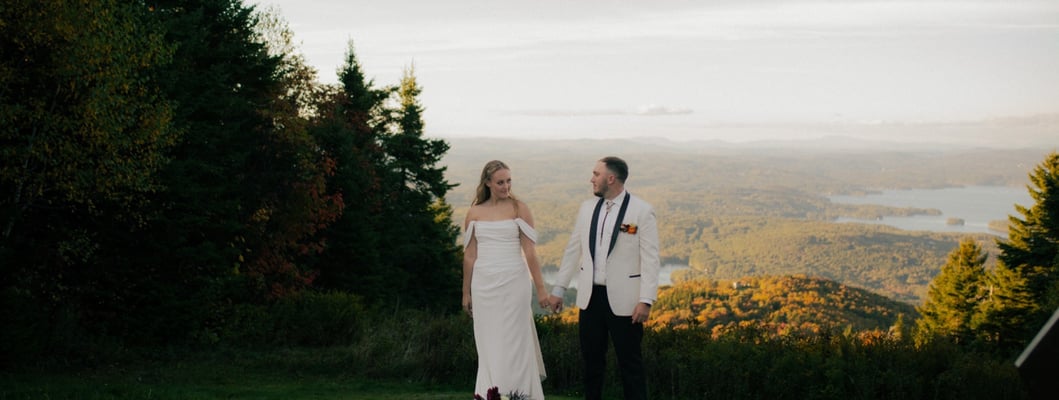 Bride and Groom standing at the top of Mount Sunapee Resort