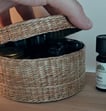 a straw box full of essential oil bottles