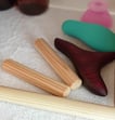 a variety of wooden massage tools on a shelf