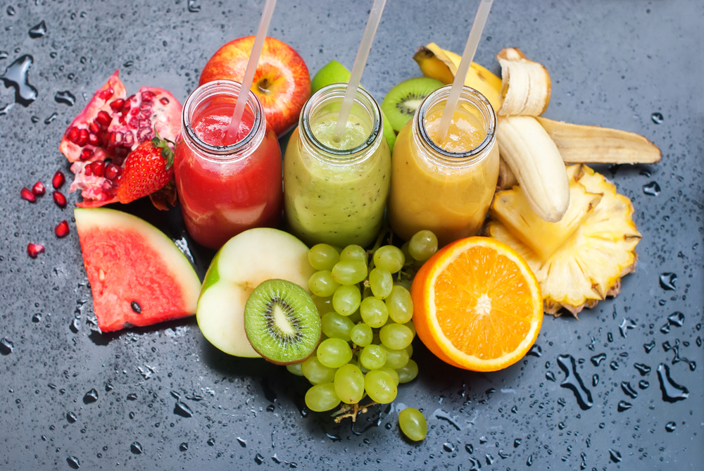 a variety of fruits and juices on a table