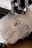 a beige cap being embroidered with anchor design