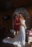 Bride getting wedding dress on in a cabin in jasper