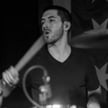 a man playing drums in a band