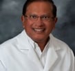 a man in a lab coat and glasses