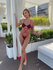 A woman in a bikini suit standing on a deck