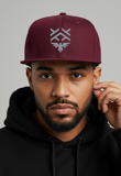 a man in a black hoodie and a maroon hat