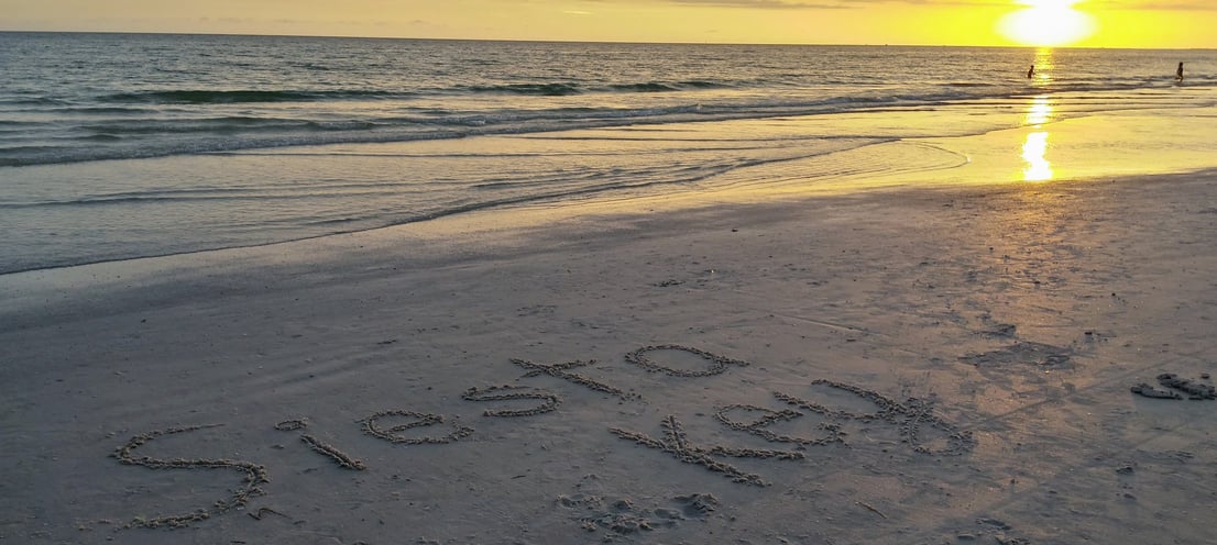 photo of the words Siesta Key written in the sand on Siesta Key