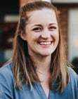 a smiling image of Amy Keeble, coach at Next Chapter Coaching, with long hair and a blue shirt