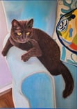 a black cat sitting on a blue chair