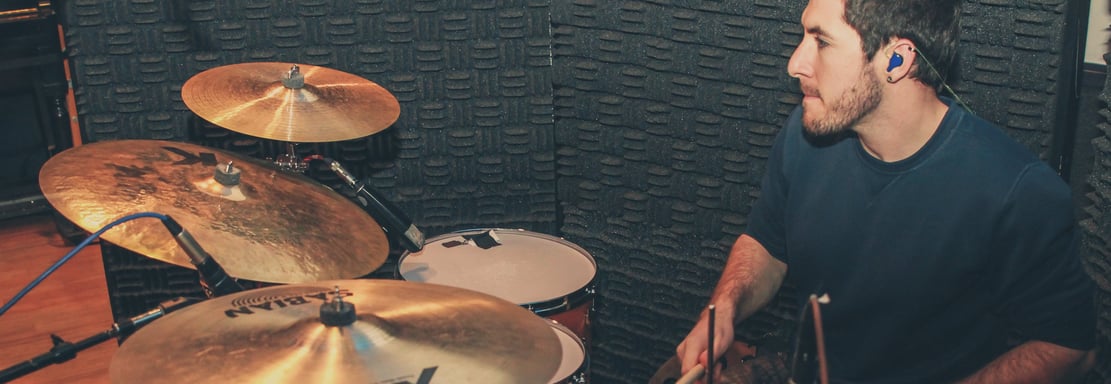a man recording drums for an artist