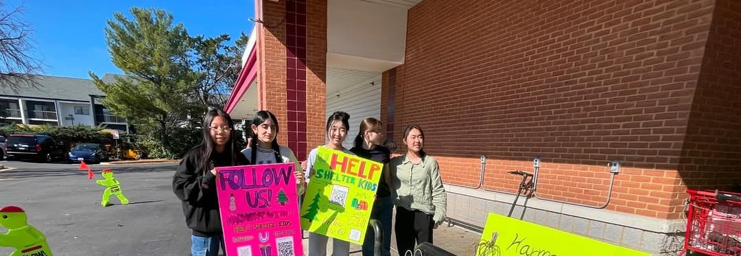 a group of people holding signs in front of a building