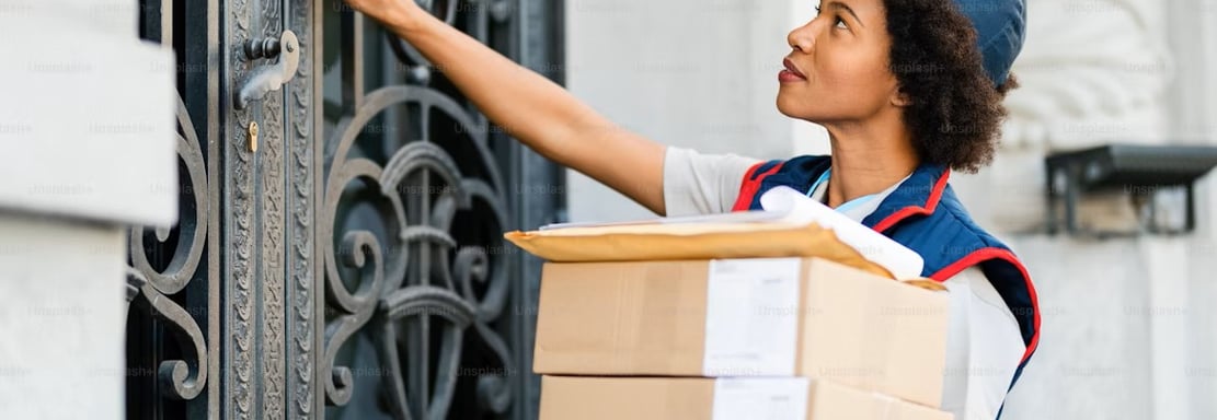 a woman in a blue uniform is holding a box with a box of boxes