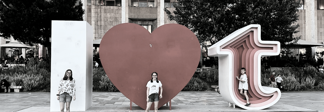 kids in front of 1 heart tirana sign in albania