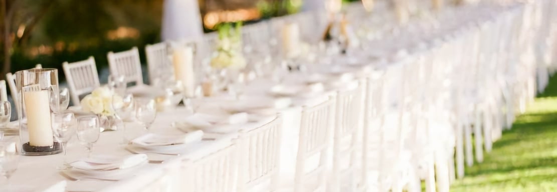 a long table with white chairs and tables