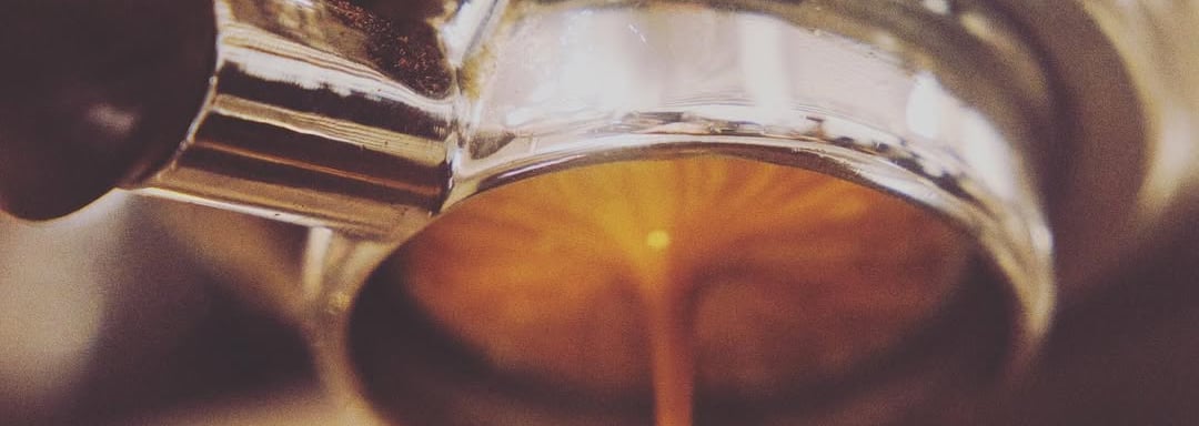 a coffee maker is making a cup of coffee