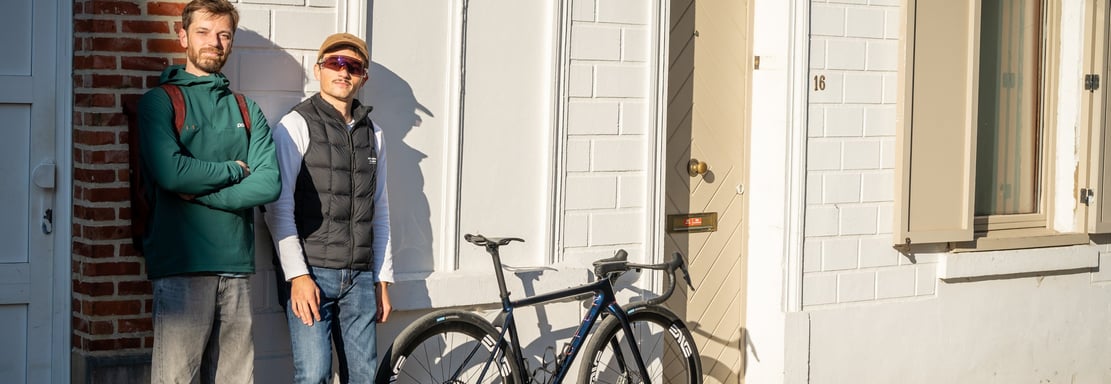 2 men standing next to a custom OPEN CYCLEbicycle