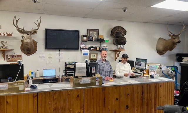 Paul and Gilbert working at front counter