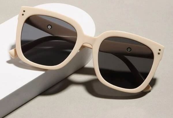 a pair of sunglasses with a white box and a white box