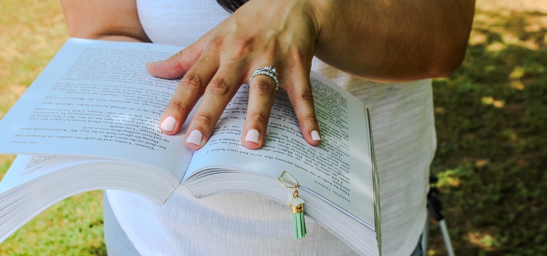 holding book with clip bookmark