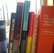 Coffee cup and windowsill of books about writing and editing