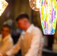 a man and woman standing in front of a bar