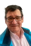 realportrait a man in a blue jacket and glasses