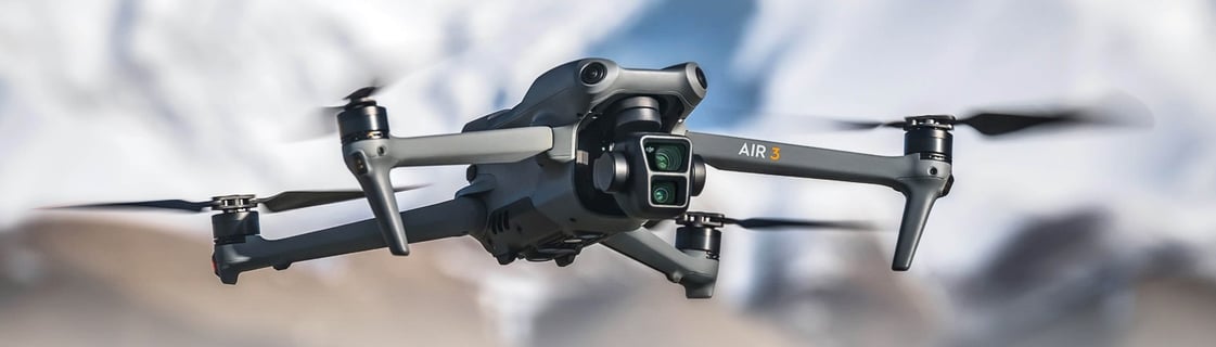 DJI Air 3: a small drone flying over a mountain