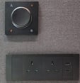 Power outlet panel with dial switch on felt wall