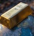 gold bar on a globe symbolizing the importance