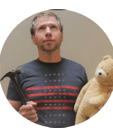 a man looking up holding a hammer and a teddy bear