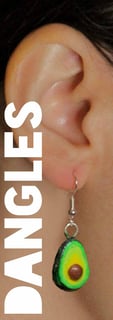a woman wearing a green avocado earrings