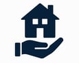 A hand holding a house