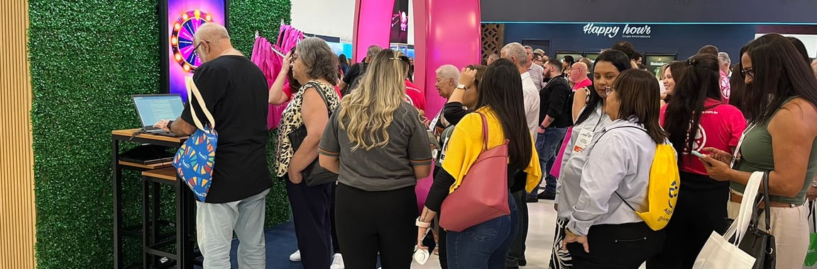 a group of people standing around a television screen