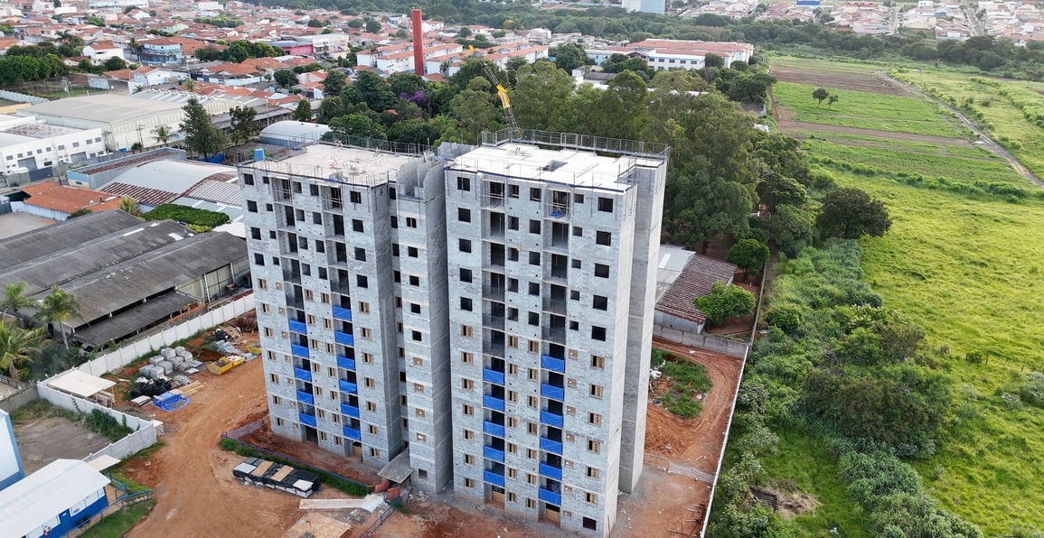 a tall building with a crane in the middle of it