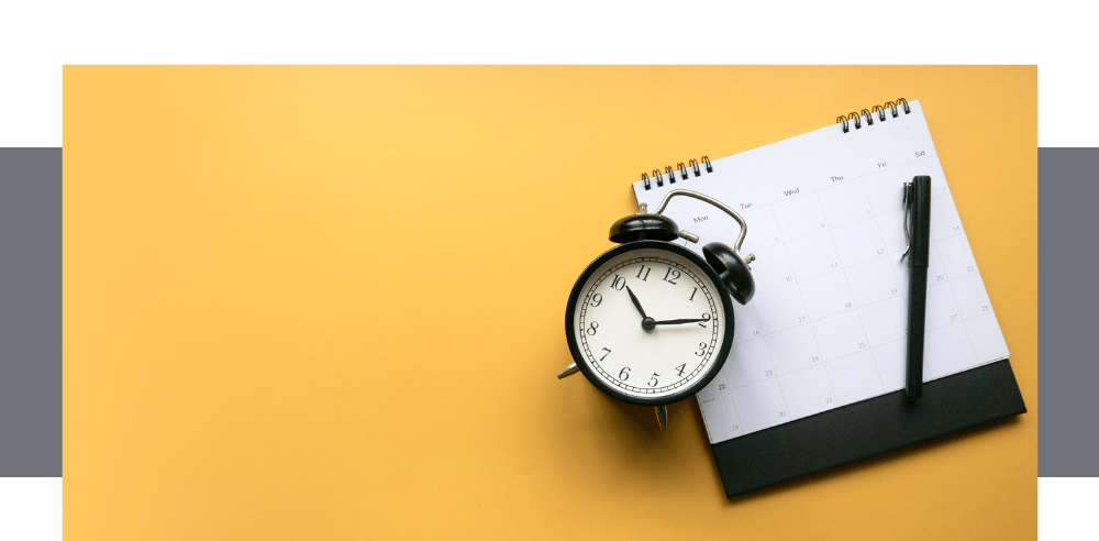 a clock and a pen and a notebook with a pen and a pen