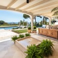 View from the shaded porch across the pool, with the Mediterranean Sea visible in the background.
