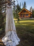 Wedding dress hanging on a tree infant of the Alpine Village Cabins