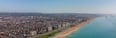a beach with a view of the ocean and a city