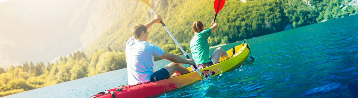 a man and woman are kayaking in a kayak